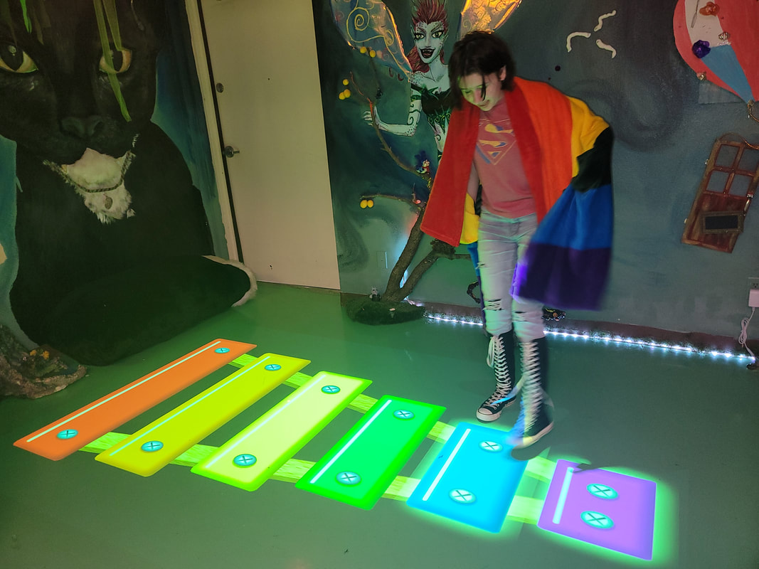 Kid stepping on multicolored instrument at Birthday Party