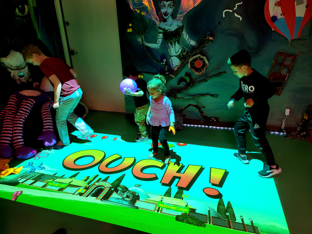 Children stepping on a projection